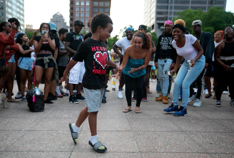 Ray Kaigler, 6, dances in front of a group of people who came together to celebrate Juneteenth at a block party in front of the Statehouse, Friday, June 19, 2020. Demonstrators, blocked off High St. at Broad and State streets.  "Juneteenth 2020, were making history!" DJ Polomoe shouted over the mic.