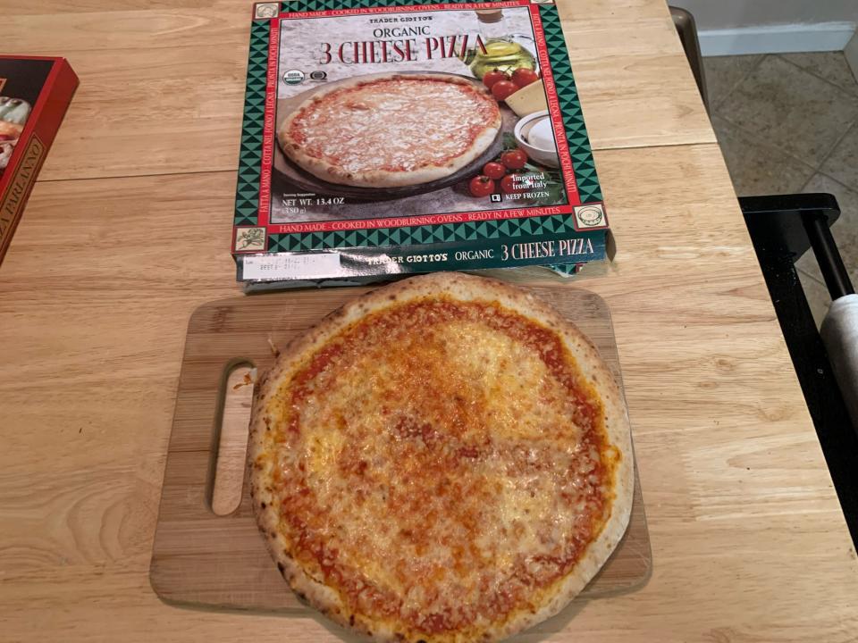 cooked Trader Joe's three cheese pizza beside original box