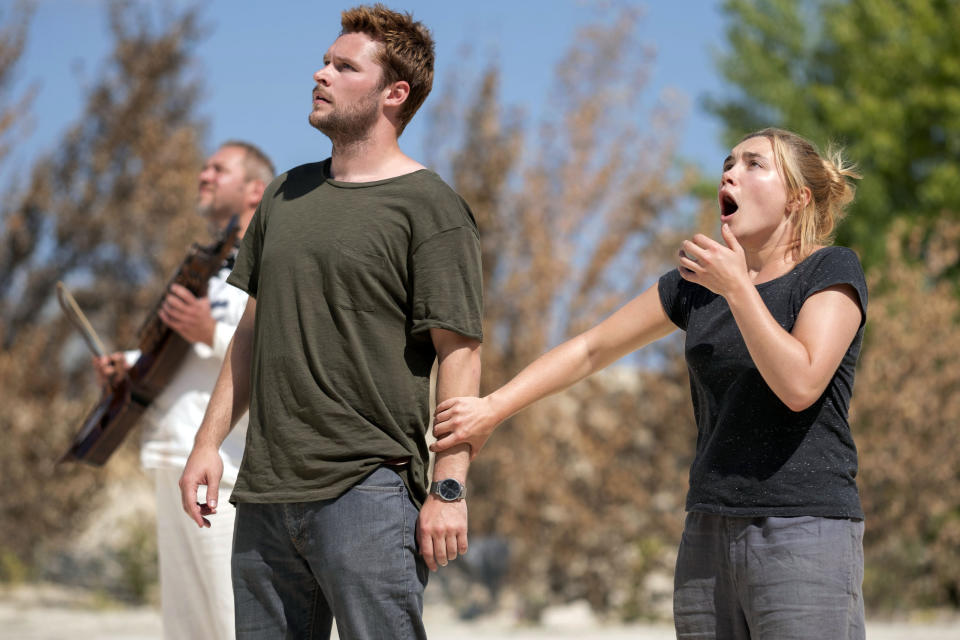 This image released by A24 shows Jack Reynor and Florence Pugh, right, in a scene from the horror film "Midsommar." (Gabor Kotschy/A24 via AP)