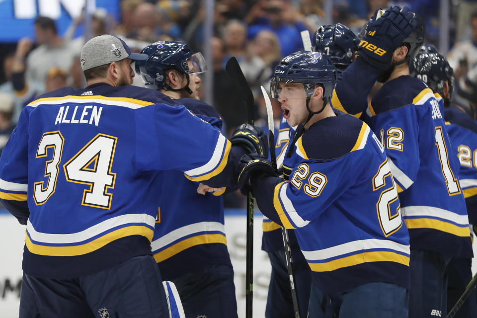 St. Louis Blues defenseman Vince Dunn (29) celebrates with goaltender Jake Allen (34) after the Blues beat the Boston Bruins in Game 4 of the NHL hockey Stanley Cup Final Monday, June 3, 2019, in St. Louis. The Blues won 4-2 to even the series 2-2. (AP Photo/Jeff Roberson)