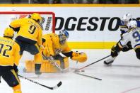 Feb 10, 2019; Nashville, TN, USA; Nashville Predators goaltender Juuse Saros (74) makes a save on a shot by St. Louis Blues right wing Vladimir Tarasenko (91) and center Ryan O'Reilly (90) during the third period at Bridgestone Arena. Mandatory Credit: Christopher Hanewinckel-USA TODAY Sports