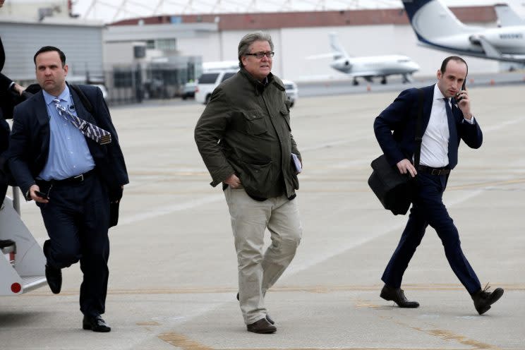 Stephen Bannon, center, walks from President Trump's plane upon their arrival in Indianapolis, Ind. (Photo: Mike Segar/Reuters)