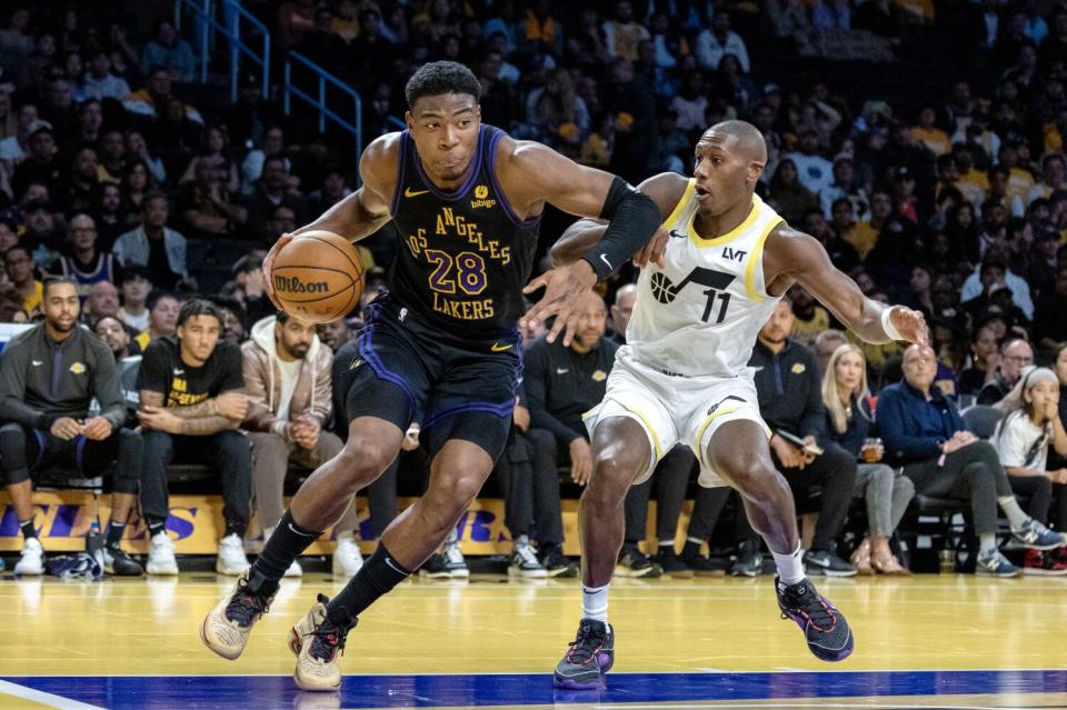 Lakers forward Rui Hachimura drives to the basket in front of Utah Jazz guard Kris Dunn at Crypton.com Arena on Tuesday.