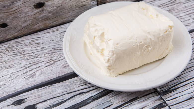 Block of cream cheese on plate