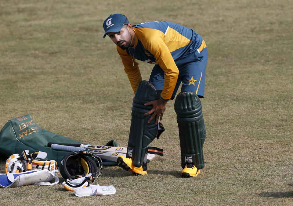 Pakistan cricket team skipper Babar Azam pads up during a practice session at the Pindi Cricket Stadium, in Rawalpindi, Pakistan, Thursday, Oct. 29, 2020. The Zimbabwe cricket team is in Pakistan to play three ODIs and three Twenty20 International match series, beginning with the first ODI on Friday. (AP Photo/Anjum Naveed)