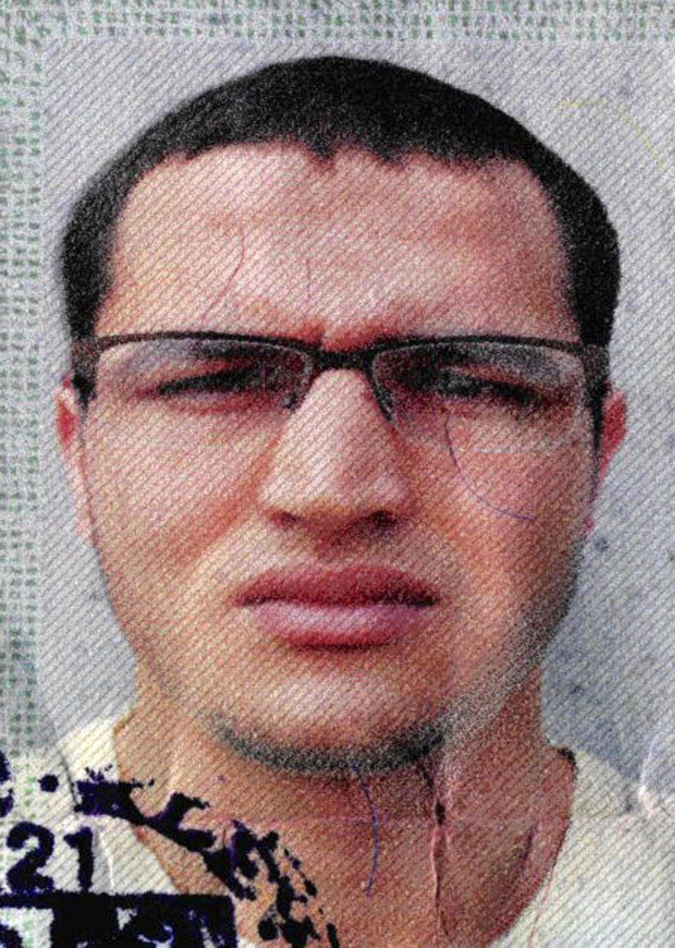 FILE -The photo issued by German federal police on Dec. 21, 2016 shows 24-year-old Tunisian Anis Amri on a photo that was used on the documents found in the truck that plowed into a Christmas market in Berlin Dec. 19. Prosecutors in western Germany say Thursday Dec. 29, 2016 they opened a fraud investigation earlier this year against Anis Amri, the main suspect in last week's Berlin truck attack, suspecting that he simultaneously claimed benefits in two towns under different identities. (German police via AP)