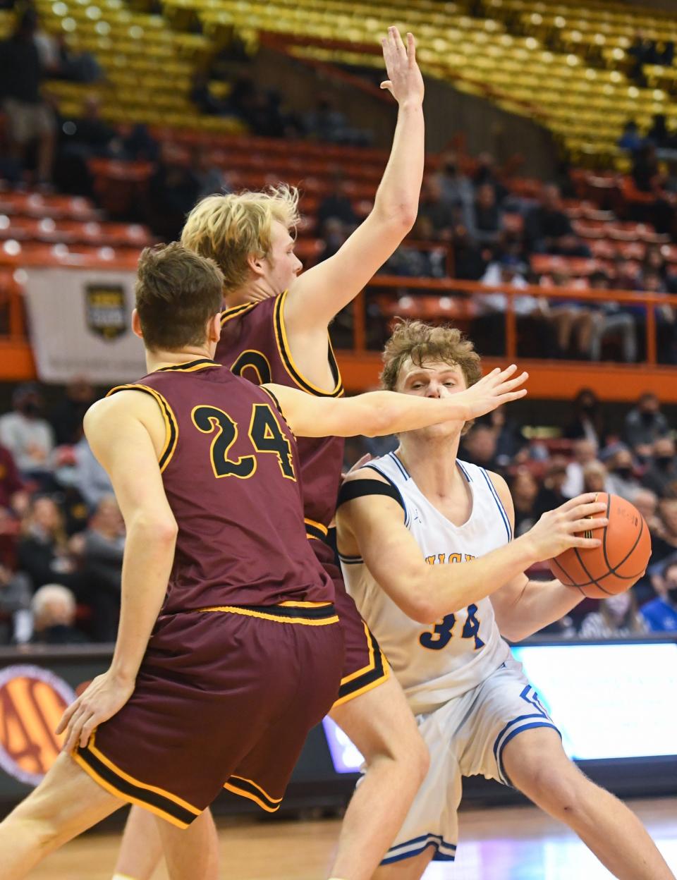 O'Gorman's David Alpers is blocked at face-level by Harrisburg's Jacoby Mehrman and Nick Tschudy during the quarterfinals of the boys class AA tournament on Thursday, March 18, 2021, at the Rushmore Plaza Civic Center in Rapid City.
