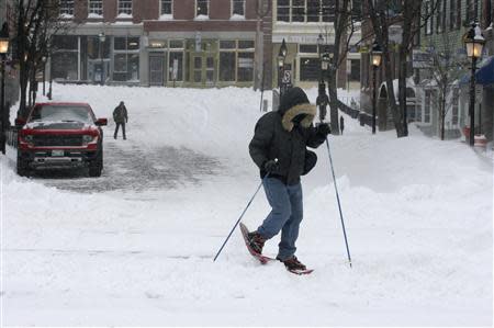 Jason Gallant snowshoes to work after a snowstorm in Portland, Maine December 15, 2013. REUTERS/Joel Page