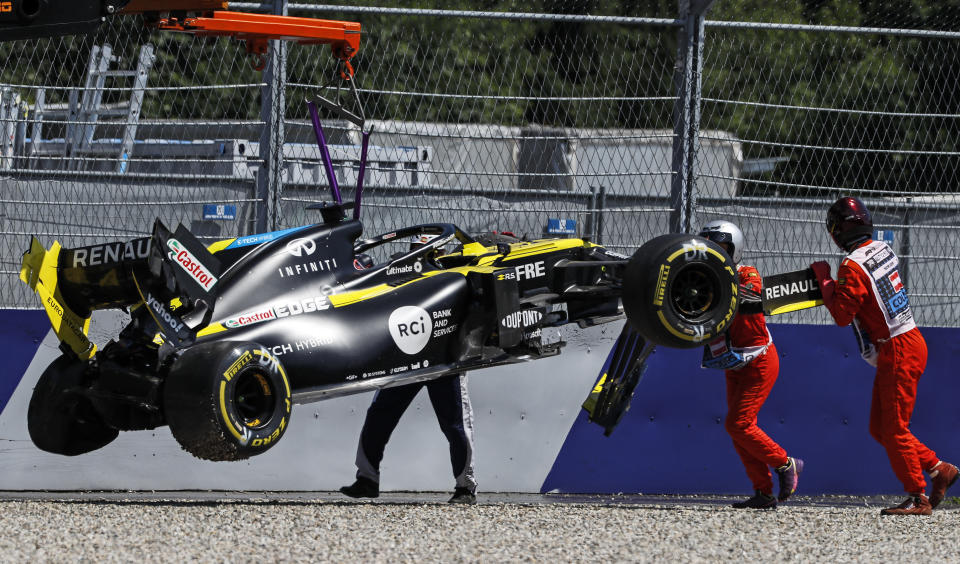 The car of Renault driver Daniel Ricciardo of Australia is lifted after crashing into the barriers during the second practice session for the Styrian Formula One Grand Prix at the Red Bull Ring racetrack in Spielberg, Austria, Friday, July 10, 2020. The Styrian F1 Grand Prix will be held on Sunday. (Leonhard Foeger/Pool via AP)