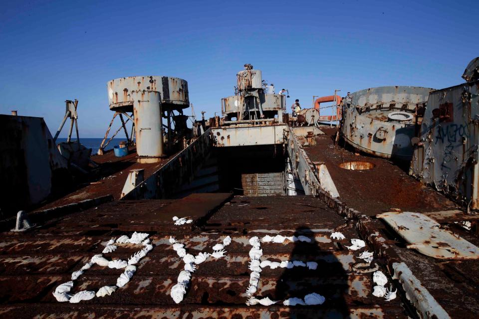 Sea shells spell out the word "bye" on top of the rusted deck of the BRP Sierra Madre.
