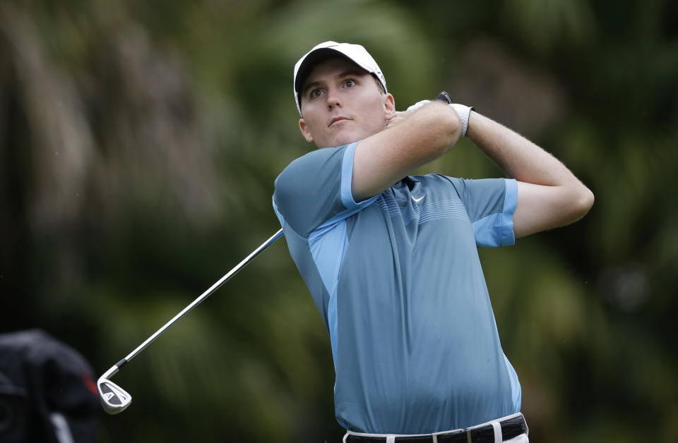 Russell Hunley watches from the 13th tee during the first round of the Cadillac Championship golf tournament Thursday, March 6, 2014, in Doral, Fla. (AP Photo/Wilfredo Lee)