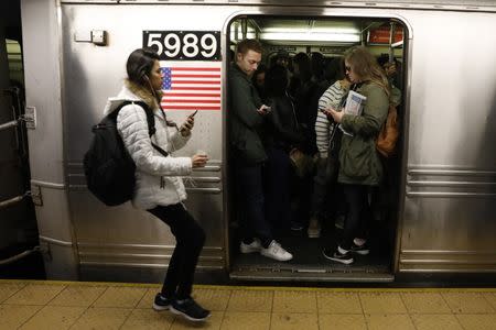 Passengers wait inside a stopped C subway train in New York City, April 21, 2017. REUTERS/Brendan Mcdermid