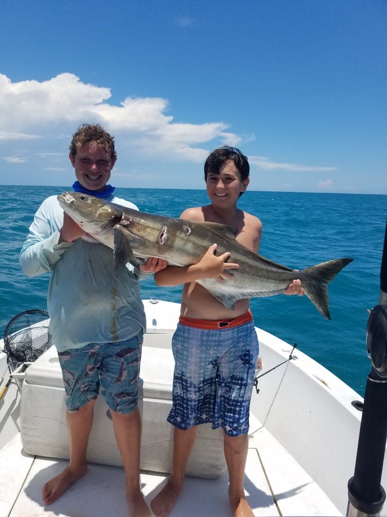 Denton Potter and John Amico hold a 37.5 pound cobia caught June 7, 2022 in 40 feet of water off St. Lucie Inlet.