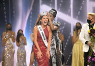 This image released by Miss Universe Organization shows Miss Universe Mexico 2020 Andrea Meza reacts as she is crowned Miss Universe by Miss Universe 2019 Zozibini Tunzi at the 69th Miss Universe Competition at the Seminole Hard Rock Hotel & Casino in Hollywood, Fla. on Sunday, May 16, 2021. (Benjamin Askinas/Miss Universe via AP)