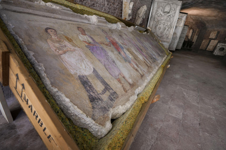 An undated fragment of a wall painting depicting deities and feminine figures and part of 750 archaeological finds from clandestine excavations on Italian territory is on display during a press conference in Rome, Wednesday, May 31, 2023. The set of artifacts, which can be dated overall between the eighth century BC. and the medieval period, and whose value is estimated at 12 million euros, was in possession of an English company in liquidation, Symes Ltd, attributable to Robin Symes, an important trafficker of cultural assets, and was repatriated from London on 19 May. (AP Photo/Domenico Stinellis)