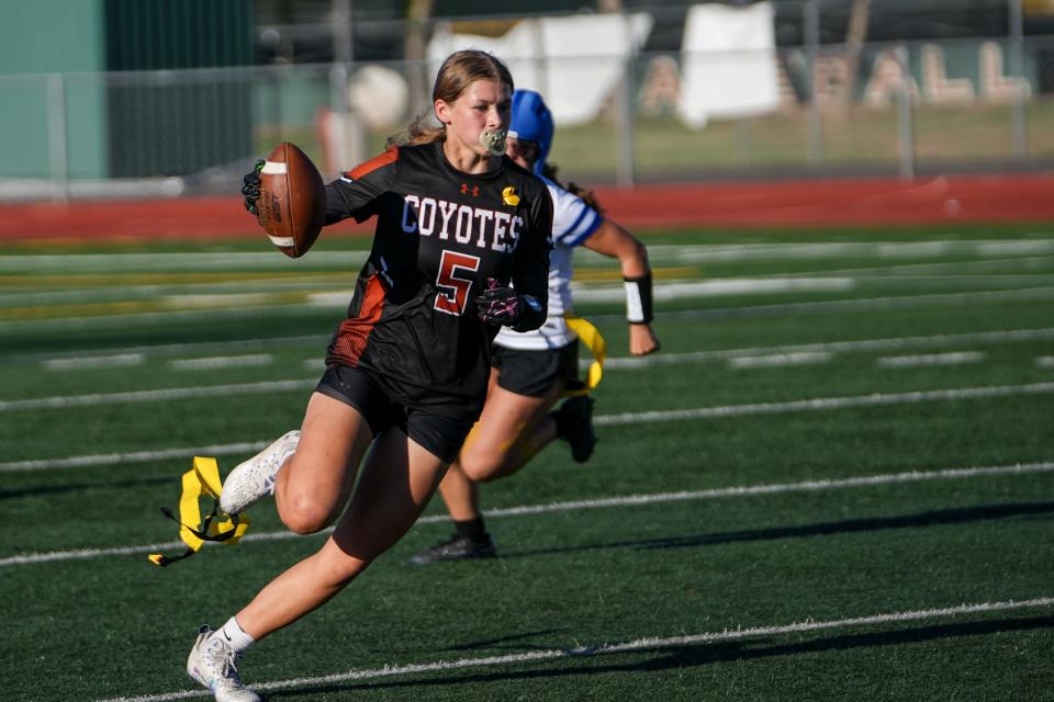 Campo Verde High School's Madison Coger (5) runs the ball during a flag football game against Canyon View High School at Campo Verde High School in Gilbert on Sept. 5, 2023.