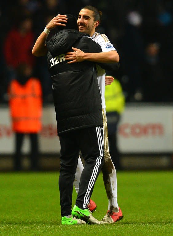 Swansea City's Spanish defender Chico Flores (R) celebrates at the final whistle of the League Cup semi-final second leg against Chelsea. Swansea beat the European Champions over two legs to reach the final against Bradford City