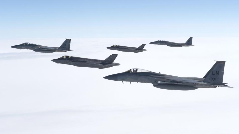 Two F-35A Joint Strike Fighters fly with a trio of F-15C Eagles. <em>USAF</em>