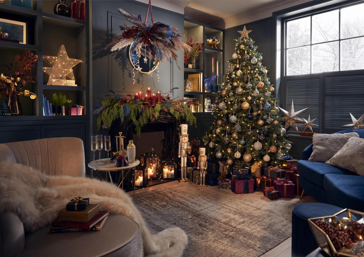  A small living room with a tree inside. 