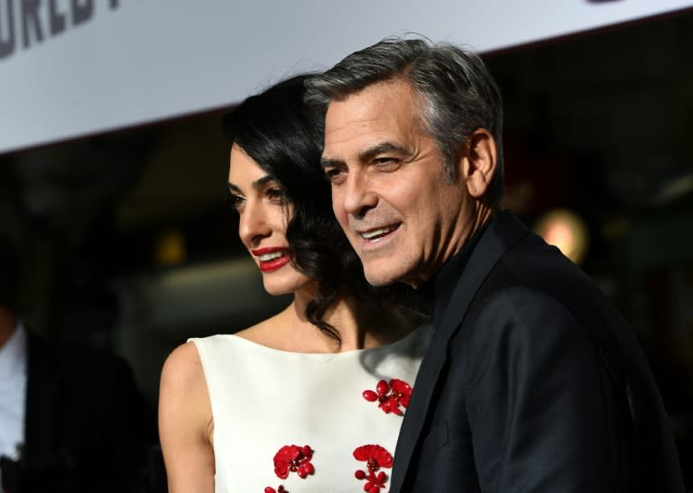 George Clooney (R), who plays a dimwit actor in "Hail Caesar", is expected on the red carpet with his wife Amal (L)