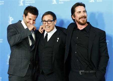 Actor Christian Bale (R-L), director David O. Russell and Bradley Cooper pose to promote the movie American Hustle at the 64th Berlinale International Film Festival in Berlin February 7, 2014. REUTERS/Tobias Schwarz