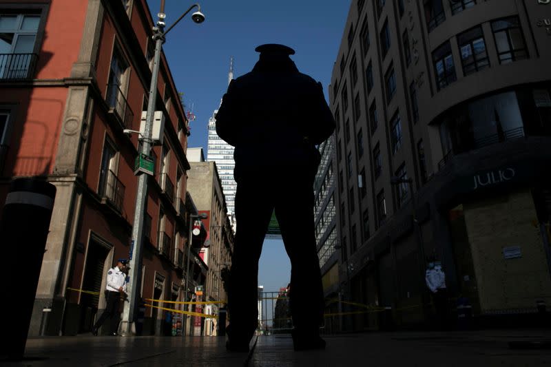 A police officer guards one of the main streets in downtown after Mexico's government declared a health emergency and issued stricter rules to curb the spread of the coronavirus disease (COVID-19), in Mexico City