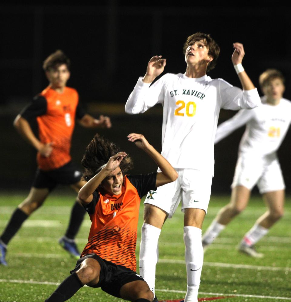 Ryle senior Diego Hoenderkamp (10) collides with St. Xavier junior Grayson Petty (20) as Ryle and St. Xavier faced off in the KHSAA boys soccer state semifinals Oct. 25, 2023 at Lafayette High School, Lexington, Ky.