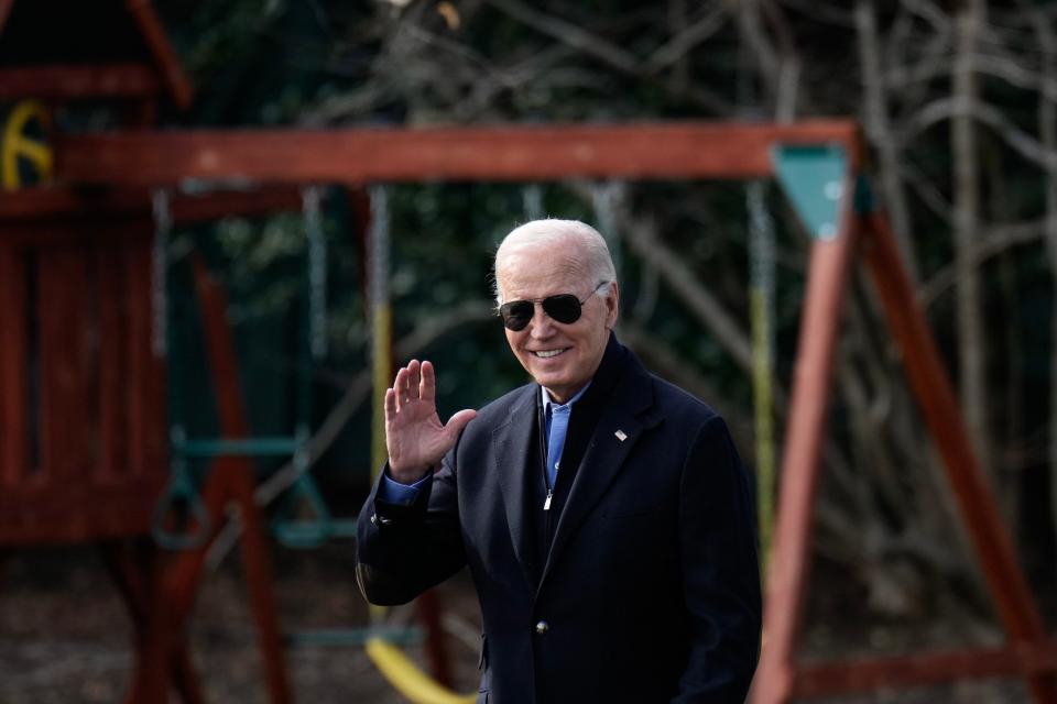 Joe Biden wearing sunglasses and waving.