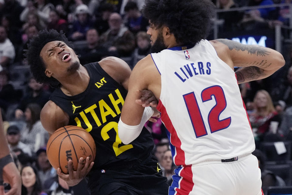 Utah Jazz guard Collin Sexton (2) is fouled by Detroit Pistons forward Isaiah Livers (12) during the second half of an NBA basketball game, Thursday, Dec. 21, 2023, in Detroit. (AP Photo/Carlos Osorio)