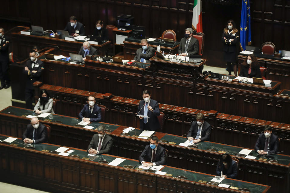 Premier Giuseppe Conte, center, delivers his speech at the lower chamber of Parliament, in Rome, Monday, Jan. 18, 2021. Conte fights for his political life with an address aimed at shoring up support for his government, which has come under fire from former Premier Matteo Renzi's tiny but key Italia Viva (Italy Alive) party over plans to relaunch the pandemic-ravaged economy. (AP Photo/Alessandra Tarantino, pool)