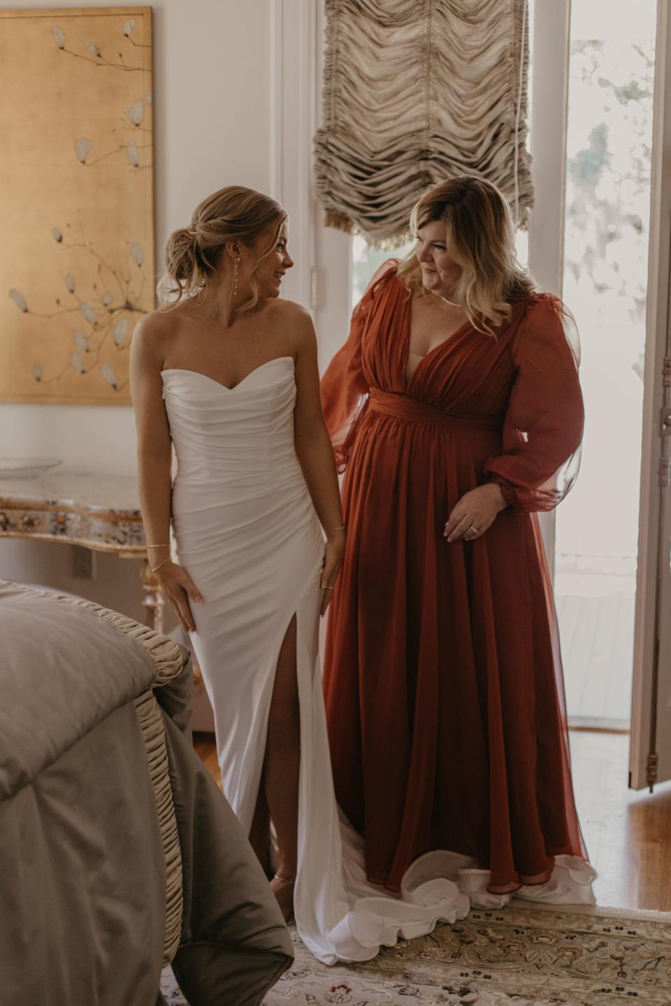 A bride and her mother look at each other on her wedding day.