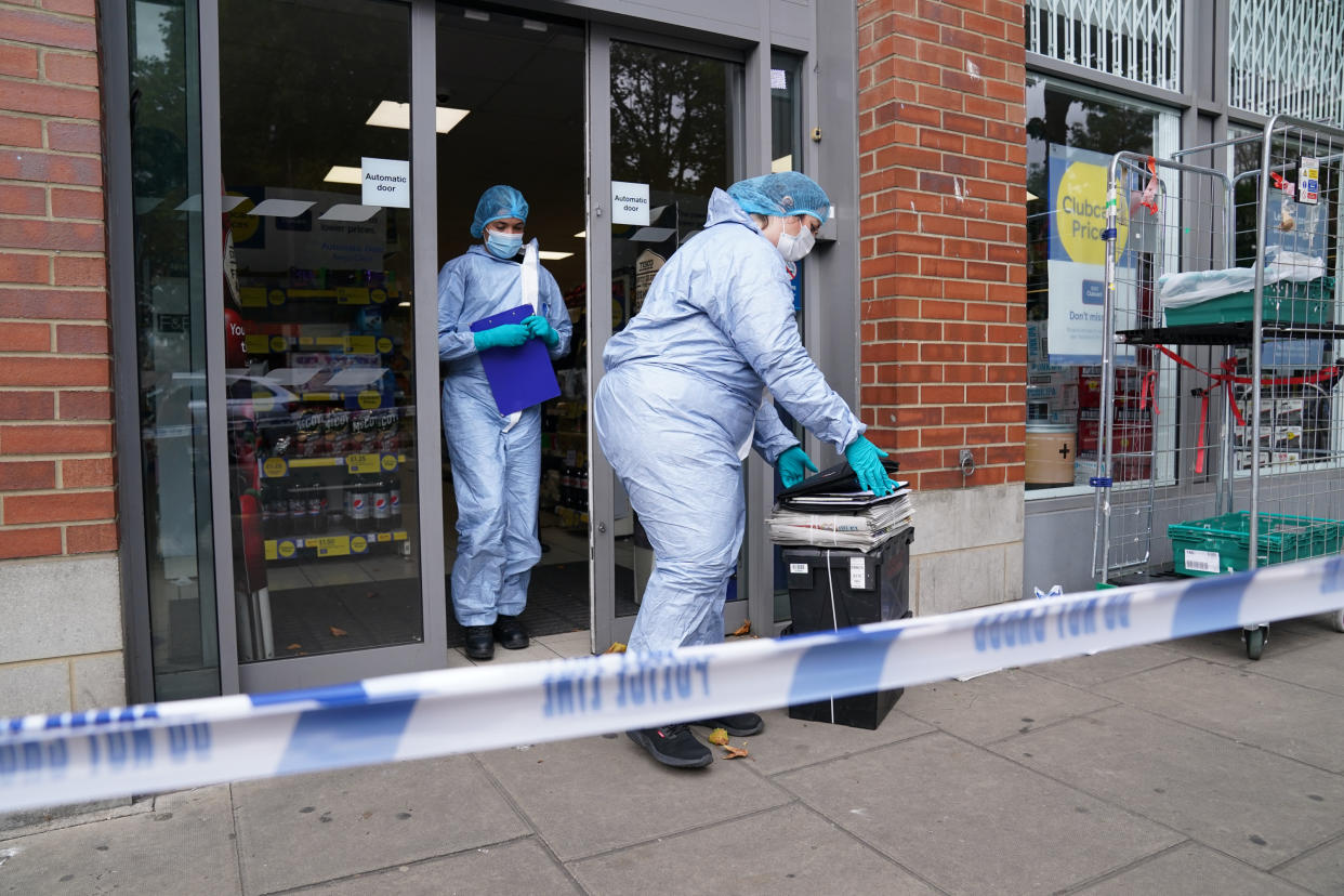 Police officers in forensic suits outside Tesco Express on Fulham Palace Road, west London, which has been closed and a crime scene put in place after a man was arrested on suspicion of contaminating food with a syringe. Police were called on Wednesday evening to a man shouting abuse at people in the street and three supermarkets Tesco Express, Little Waitrose and Sainsbury's Local - have been closed for investigation. Picture date: Thursday August 26, 2021.