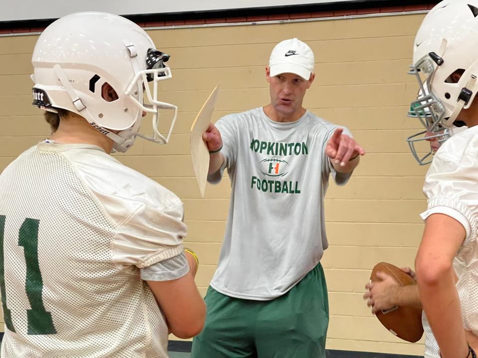 Hopkinton football coach Mark Sanborn instructs his players during Friday morning's indoor practice.