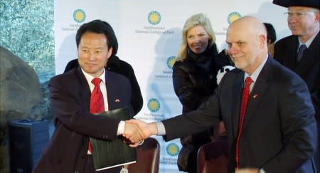 FILE PHOTO: Chinese Ambassador to U.S. Chen Wangxia shakes hands with Dennis Kelly, Director, Smithsonian's National Zoological Park after signing new Giant Panda loan agreement in Washington