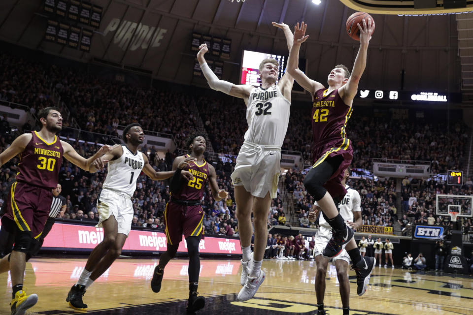 Purdue center Matt Haarms (32) goes up to block the shot ov Minnesota forward Michael Hurt (42) during the first half of an NCAA college basketball game in West Lafayette, Ind., Thursday, Jan. 2, 2020. (AP Photo/Michael Conroy)