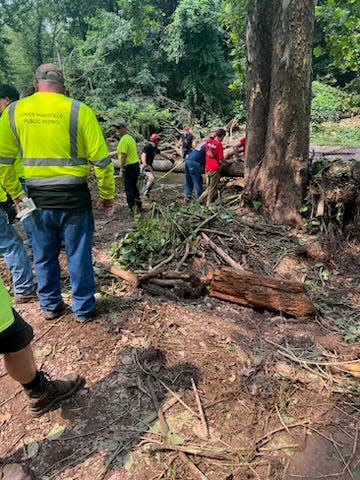 These photos taken July 17-18, 2023 show first responder volunteers digging and checking Houghs Creek by hand on in the debris fields to see which piles could be disassembled by hand.