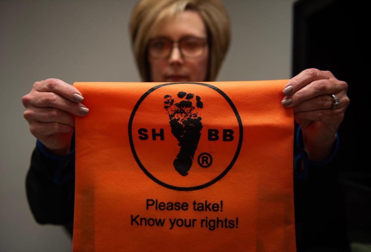 Melissa Sullivan, Crisis Pregnancy Center executive director, holds up a bag that is placed inside the Safe Haven Baby Box at Simpson General Hospital in Mendenhall, Miss., on Tuesday, Feb. 20, 2024. The bag contains information on resources for the parent relinquishing their infant.