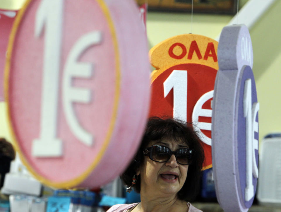 Signs advertising that each item of merchandise is on sale for one euro are seen in a discount shop in central Athens on Friday, May 25, 2012. Uncertainty over Greece's future in the eurozone has hammered markets ahead of June 17 general elections in the crisis-hit country. The Greek share index touched new 22-year lows, dipping below 500 points on Friday. (AP Photo/Thanassis Stavrakis)