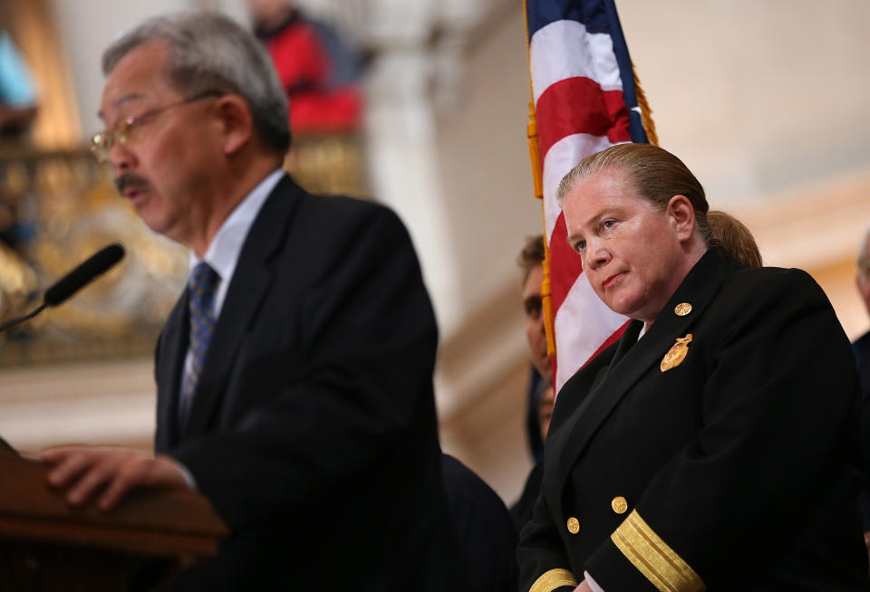 SAN FRANCISCO, CA - MARCH 26:  San Francisco fire department chief Joanne Hayes-white (R) looks on as San Francisco mayor Ed Lee speaks during a remembrance ceremony held for San Francisco firefighters who have died of cancer on March 26, 2014 at San Francisco City Hall in San Francisco, California. Over two hundred pairs of boots were displayed on the steps inside San Francisco City Hall to symbolize the 230 San Francisco firefighters who have died of cancer over the past decade. According to a study published by the National Institute for Occupational Safety and Health, (NIOSH)  findings indicate a direct correlation between exposure to carcinogens like flame retardants and higher rate of cancer among firefighters. The study showed elevated rates of respiratory, digestive and urinary systems cancer and also revealed that participants in the study had high risk of mesothelioma, a cancer associated with asbestos exposure.  (Photo by Justin Sullivan/Getty Images)