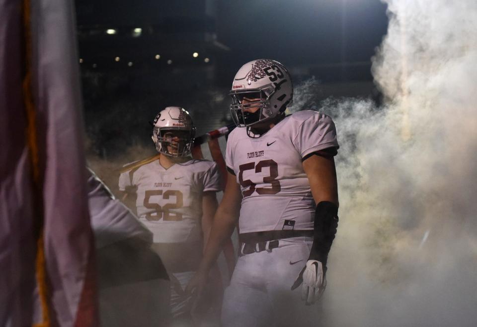 Flour Bluff's Dylan Shaw stands in smoke before the teamÕs game against Katy Paetow, Friday, Dec. 10, 2021, at Heroes Stadium in San Antonio. Katy Paetow won, 73-14.