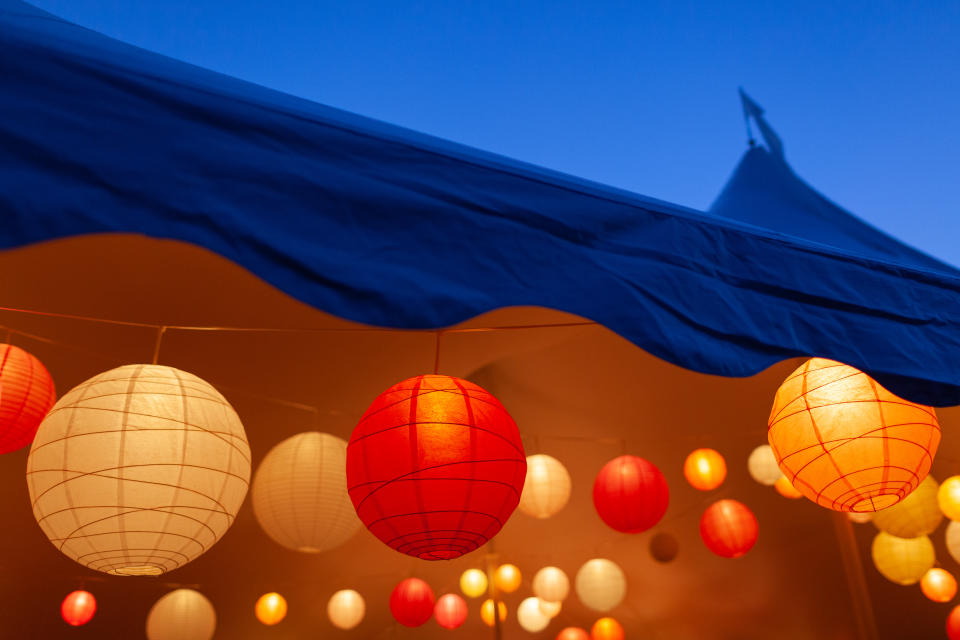 Event tent in the evening with bright paper lanterns