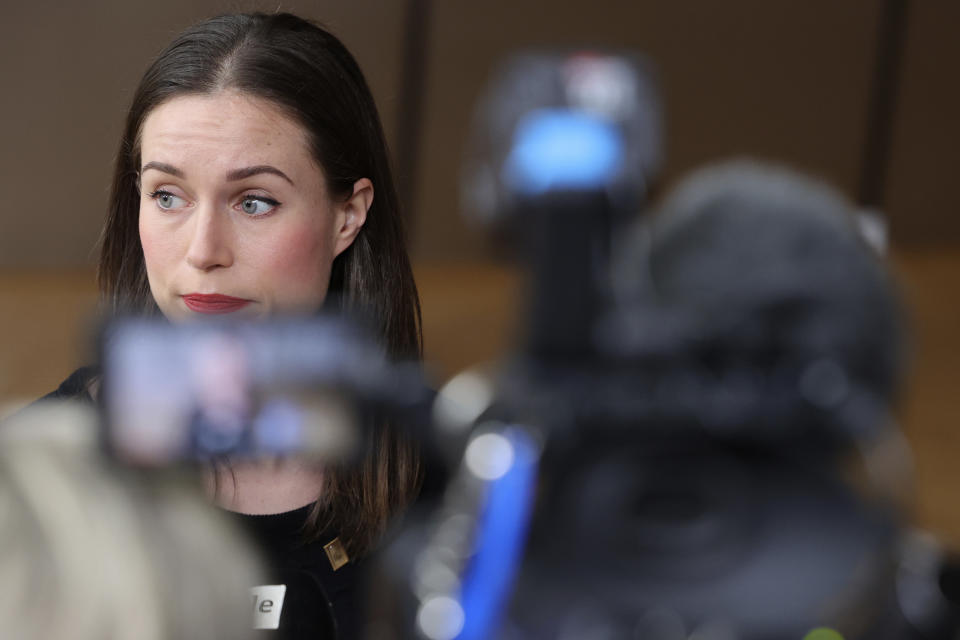 Finland's Prime Minister Sanna Marin speaks with the media as she arrives for an EU summit at the European Council building in Brussels, Friday, March 24, 2023. European leaders gather Friday to discuss economic and financial challenges and banking rules, seeking to tamp down concerns about eventual risks for European consumers from banking troubles in the US and Switzerland. (AP Photo/Olivier Matthys)