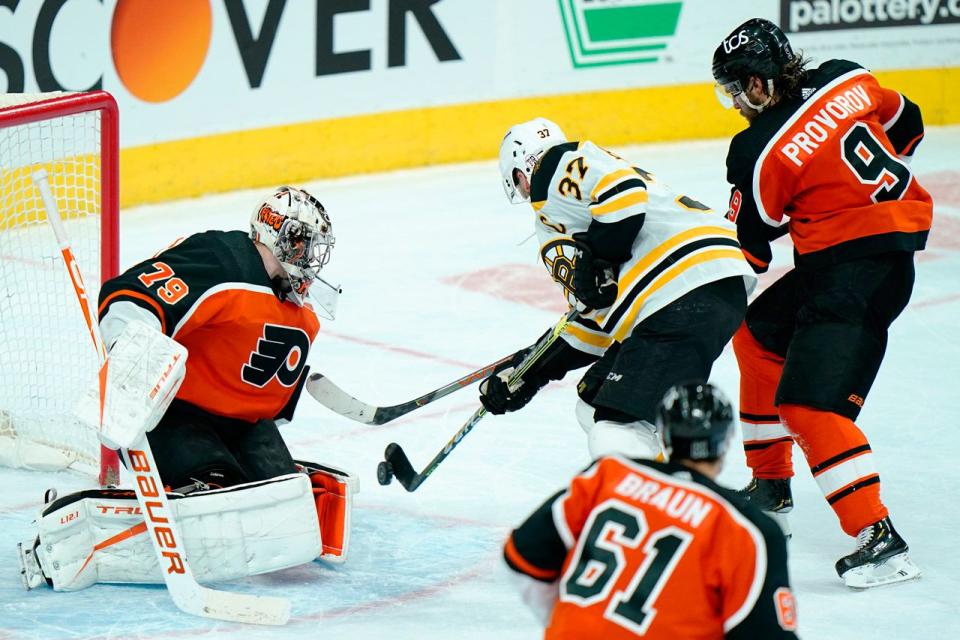 Boston Bruins' Patrice Bergeron scores the game-winning goal past Philadelphia Flyers' Carter Hart during overtime in Philadelphia, Wednesday, Feb. 3, 2021.