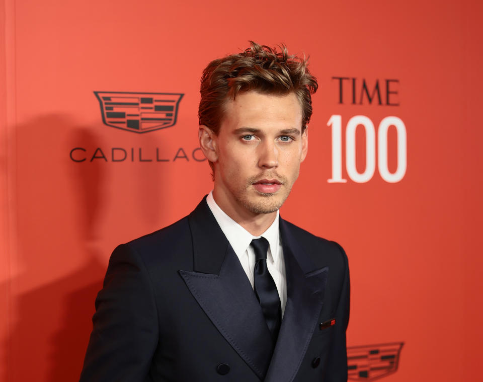 Close-up of Austin in a suit and tie at a media event