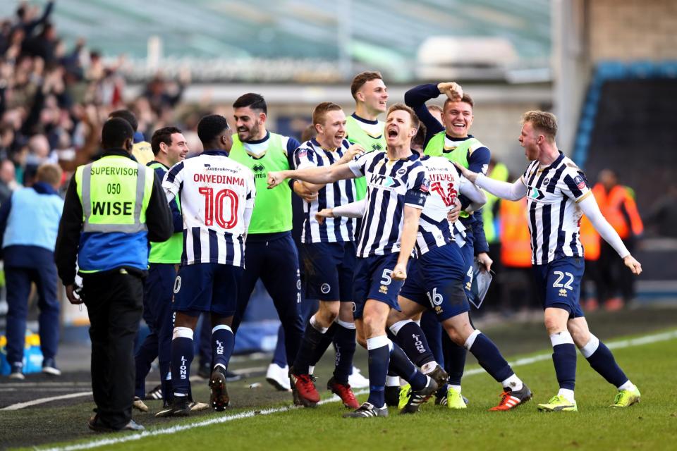 Tony Craig of Millwall (C) celebrates with his team mates after The Emirates FA Cup Fifth Round match between Millwall and Leicester City at The Den