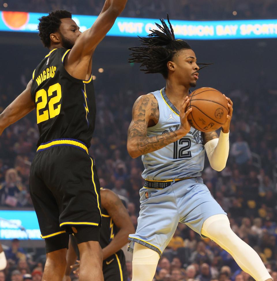 Memphis Grizzlies guard Ja Morant looks to pass the ball as Golden State Warriors guard Andrew Wiggin s defends during game three of the second round for the 2022 NBA playoffs at Chase Center on Saturday, May 7, 2022. 