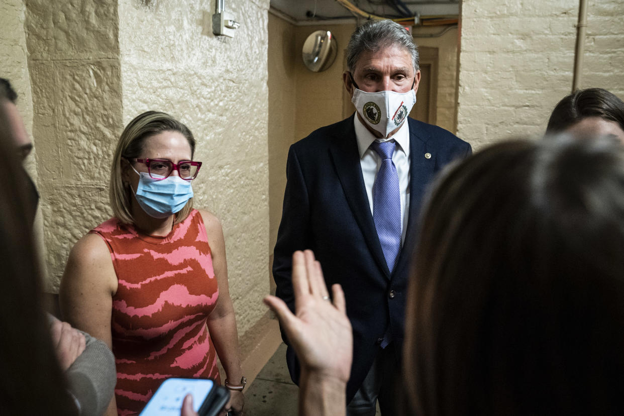 Sen. Kyrsten Sinema, D-Ariz., and Sen. Joe Manchin, D-W.Va., speak to a reporter after a private meeting between the two of them before a vote on Capitol Hill on Sept. 30, 2021, in Washington, D.C. (abin Botsford/The Washington Post via Getty Images)