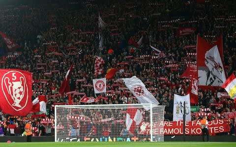 iverpool fans wave flags ahead of the Champions League Group C soccer match between Liverpool and Paris-Saint-Germain - Credit: AP