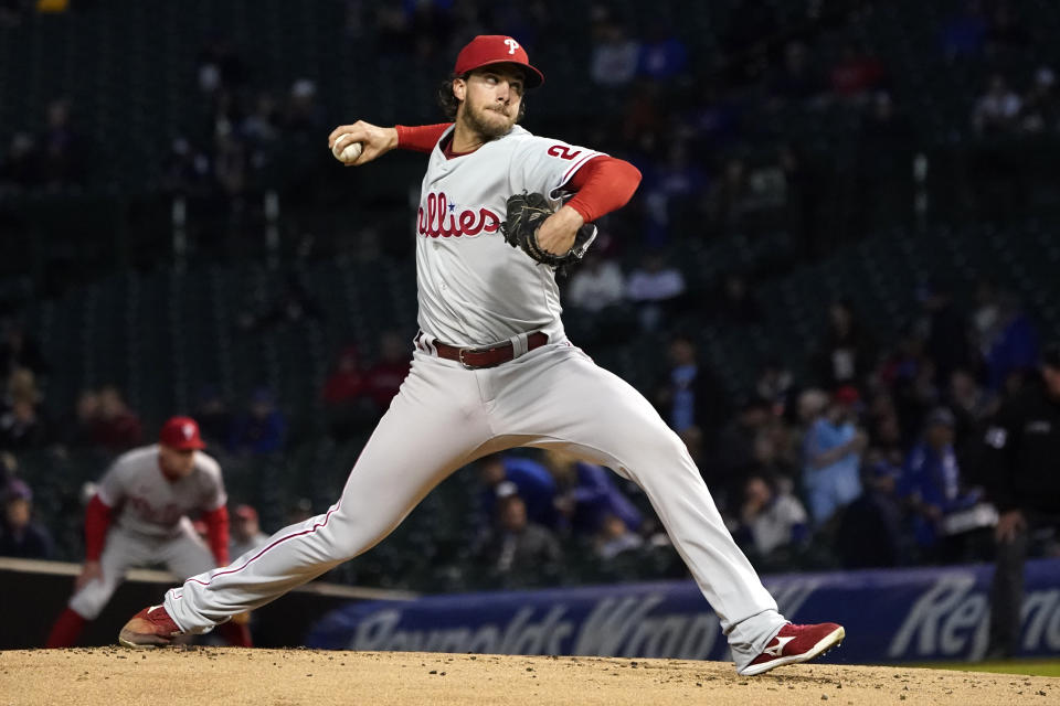 Philadelphia Phillies starting pitcher Aaron Nola winds up during the first inning of a baseball game against the Chicago Cubs Wednesday, Sept. 28, 2022, in Chicago. (AP Photo/Charles Rex Arbogast)