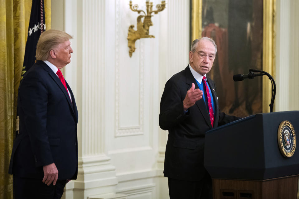 President Donald Trump listens to Sen. Chuck Grassley, R-Iowa, speak during a ceremony in the East Room of the White House where Trump spoke about his judicial appointments, Wednesday, Nov. 6, 2019, in Washington. (AP Photo/Manuel Balce Ceneta)
